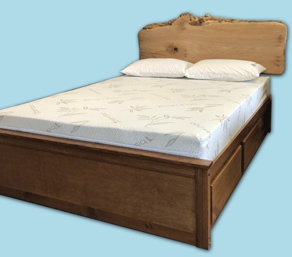 Wooden bed with unique headboard and storage drawers.