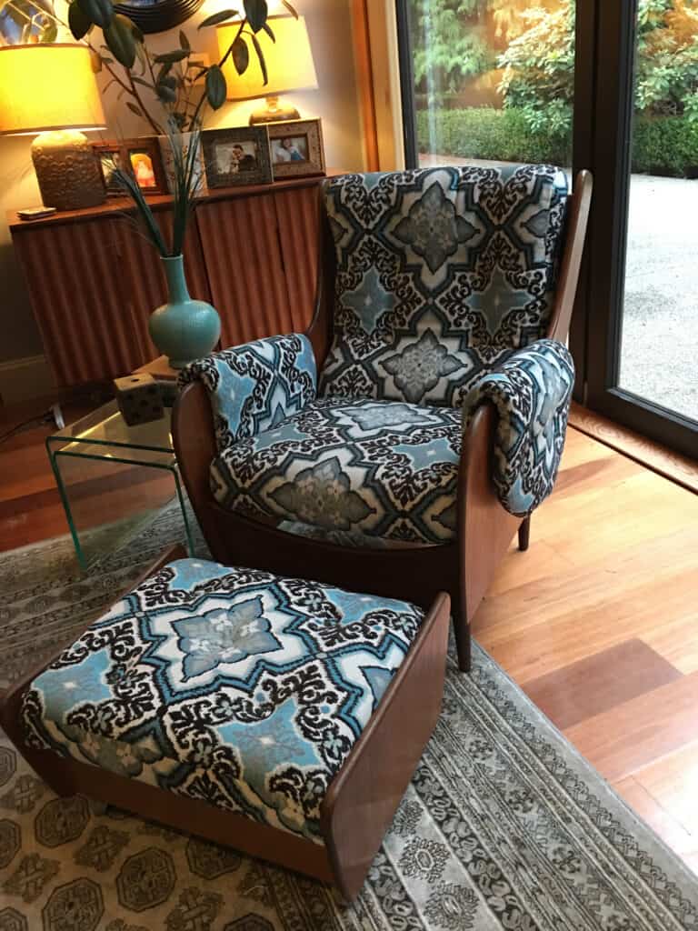 Retro armchair with patterned upholstery in living room.