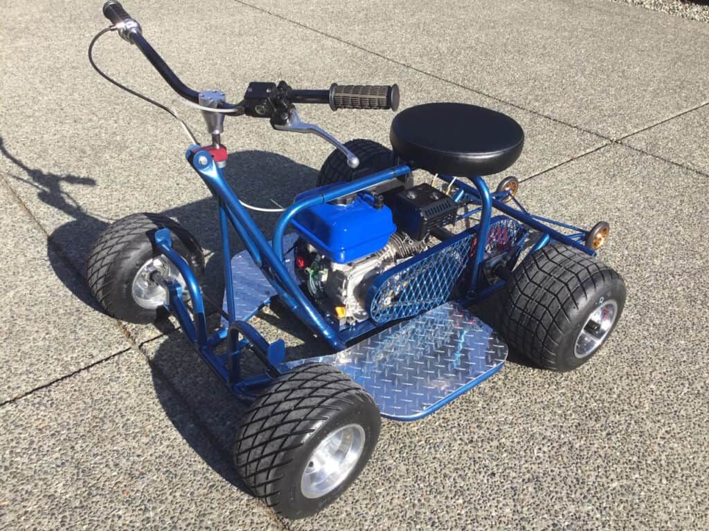 Blue motorized drift trike on pavement.