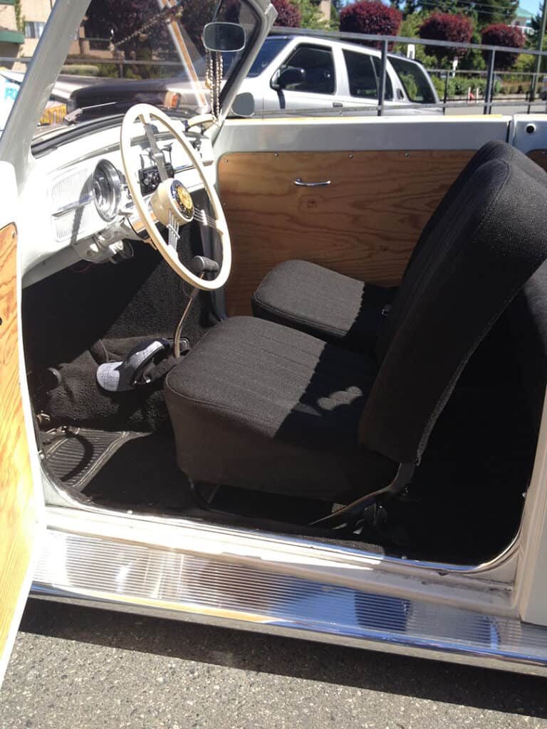 Interior of vintage car with black seats.