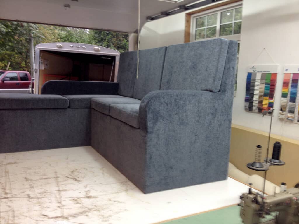 Grey sectional sofa in a workshop setting.