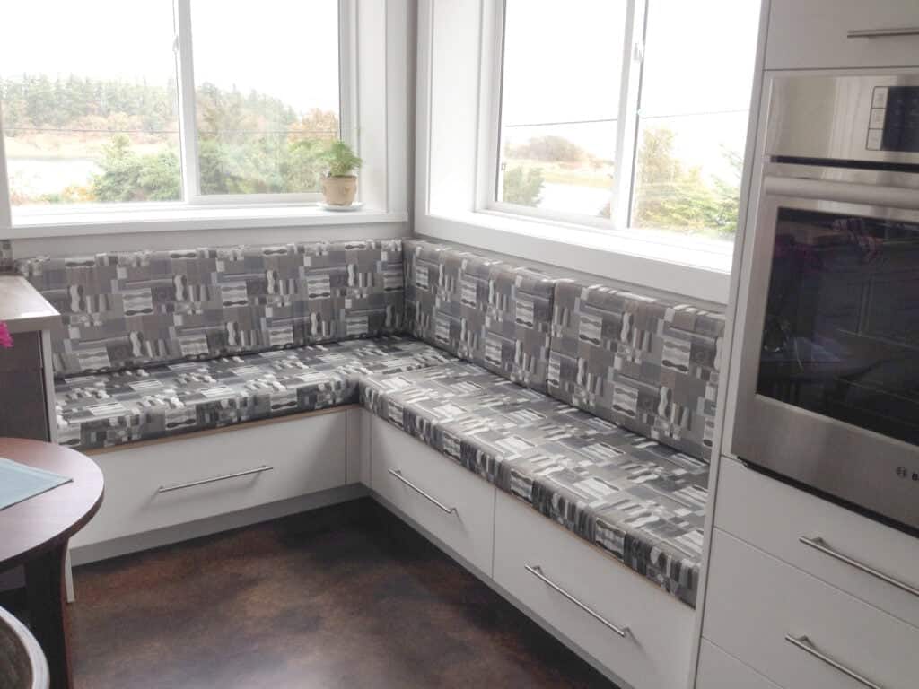 Modern kitchen with corner seating area and oven