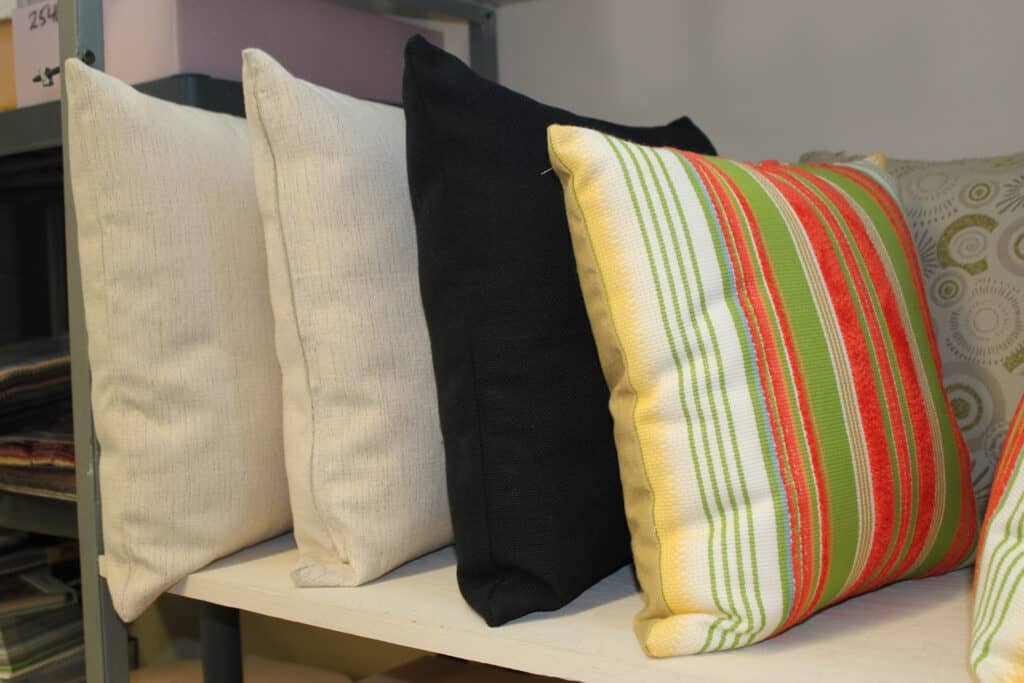 Four decorative pillows on shelf