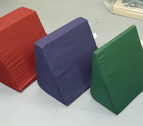 Red, blue, green foam wedges on grey floor