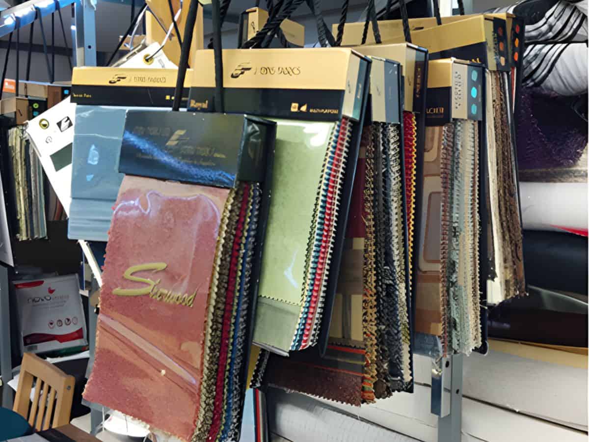 Hanging upholstery fabric samples in various colours.
