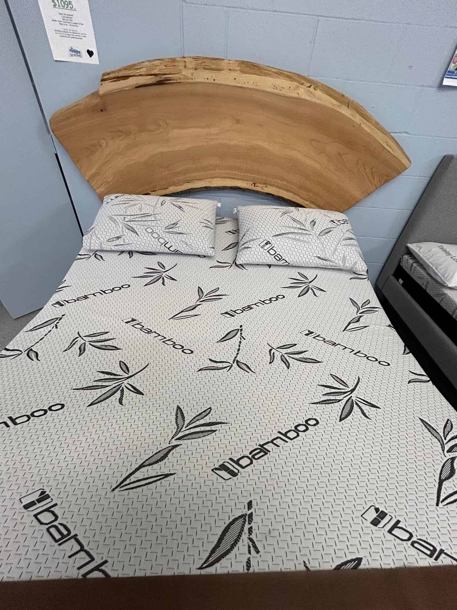 Bamboo-patterned bed with wooden headboard display.