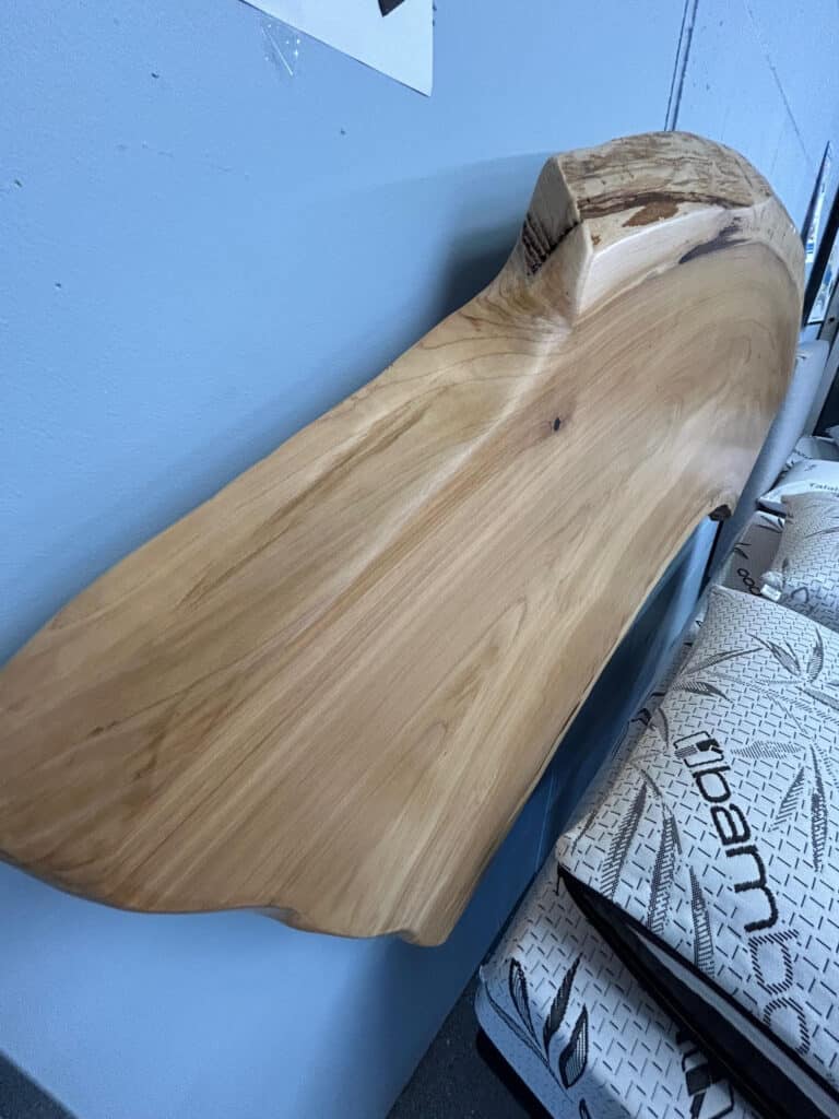 Wooden slab leaning against a blue wall